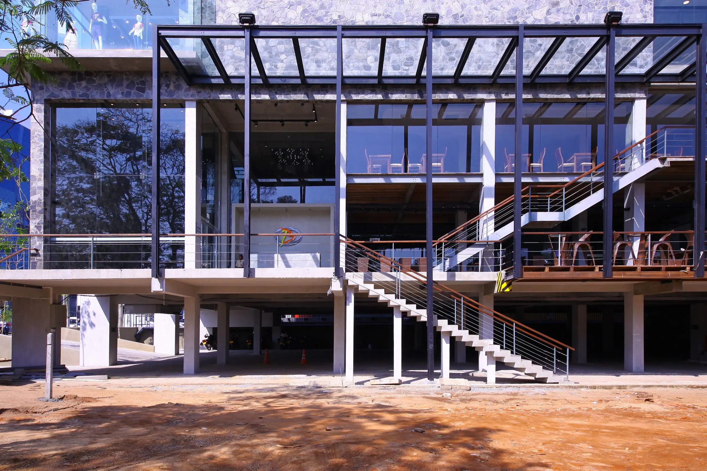 The lower floors of the building, with tall glazing and external stairs.