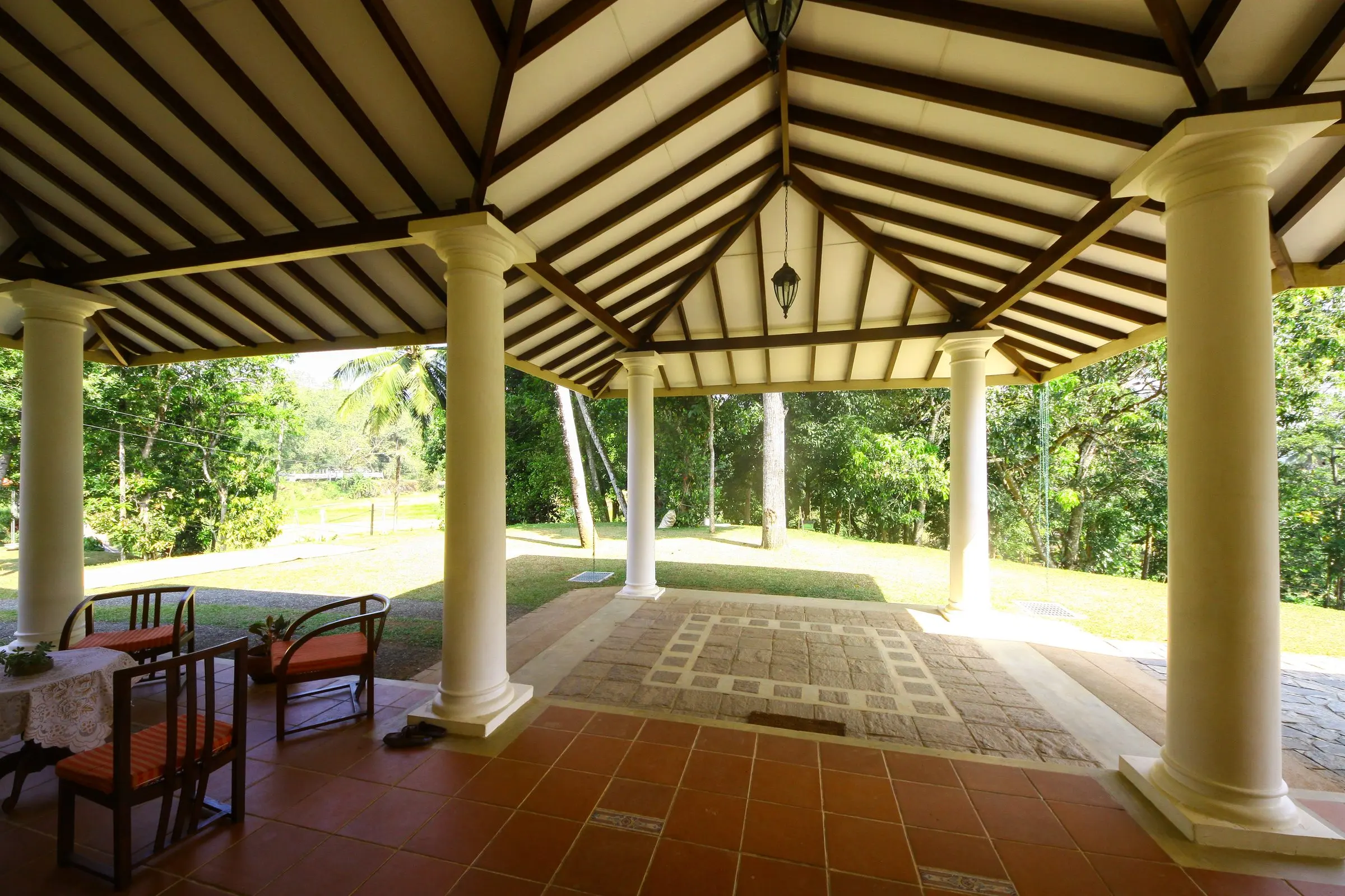 Looking out from under the pavilion roof, between white columns.