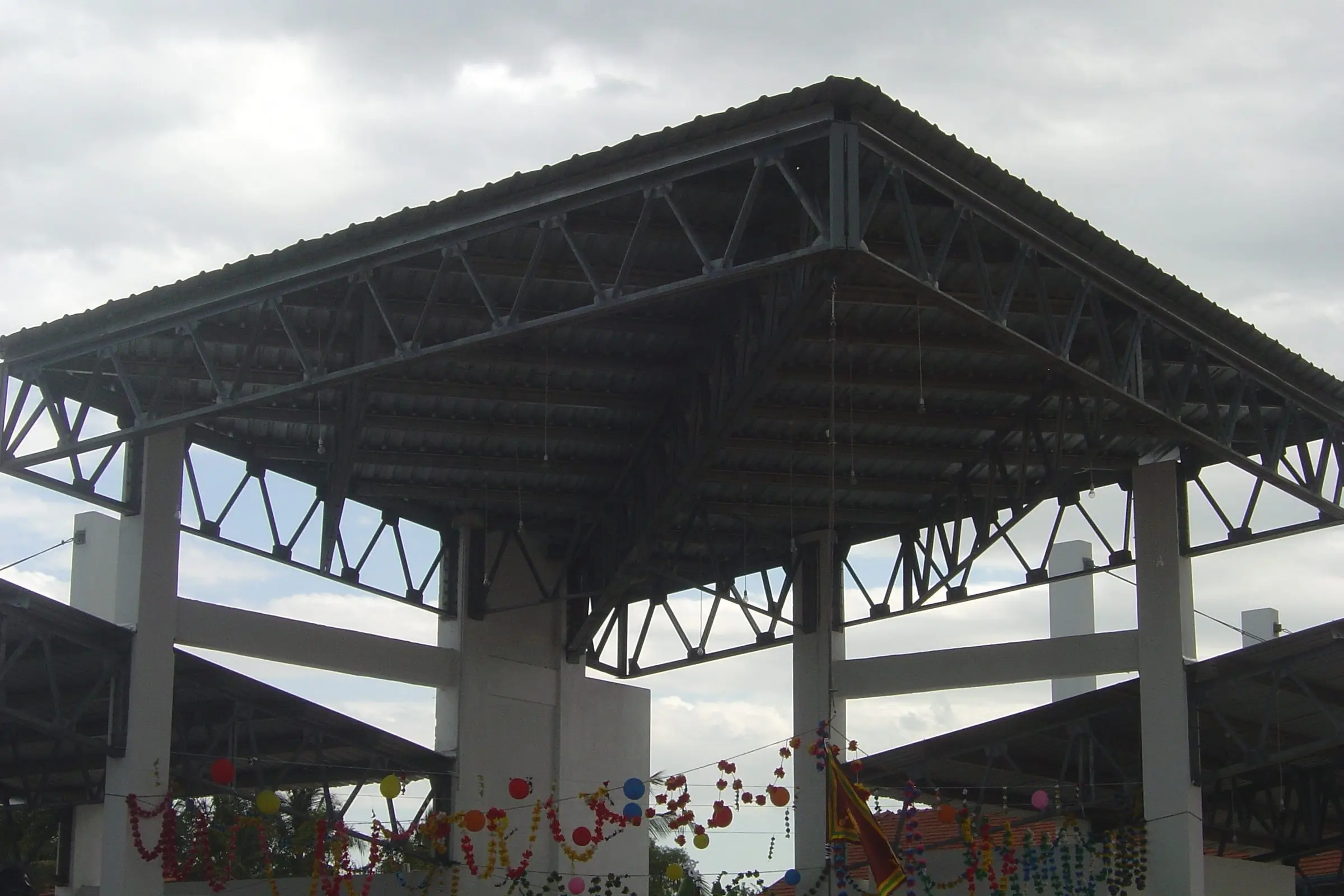 Looking up into the pavilion roof between white piers — Pavilion at Kalmunai.