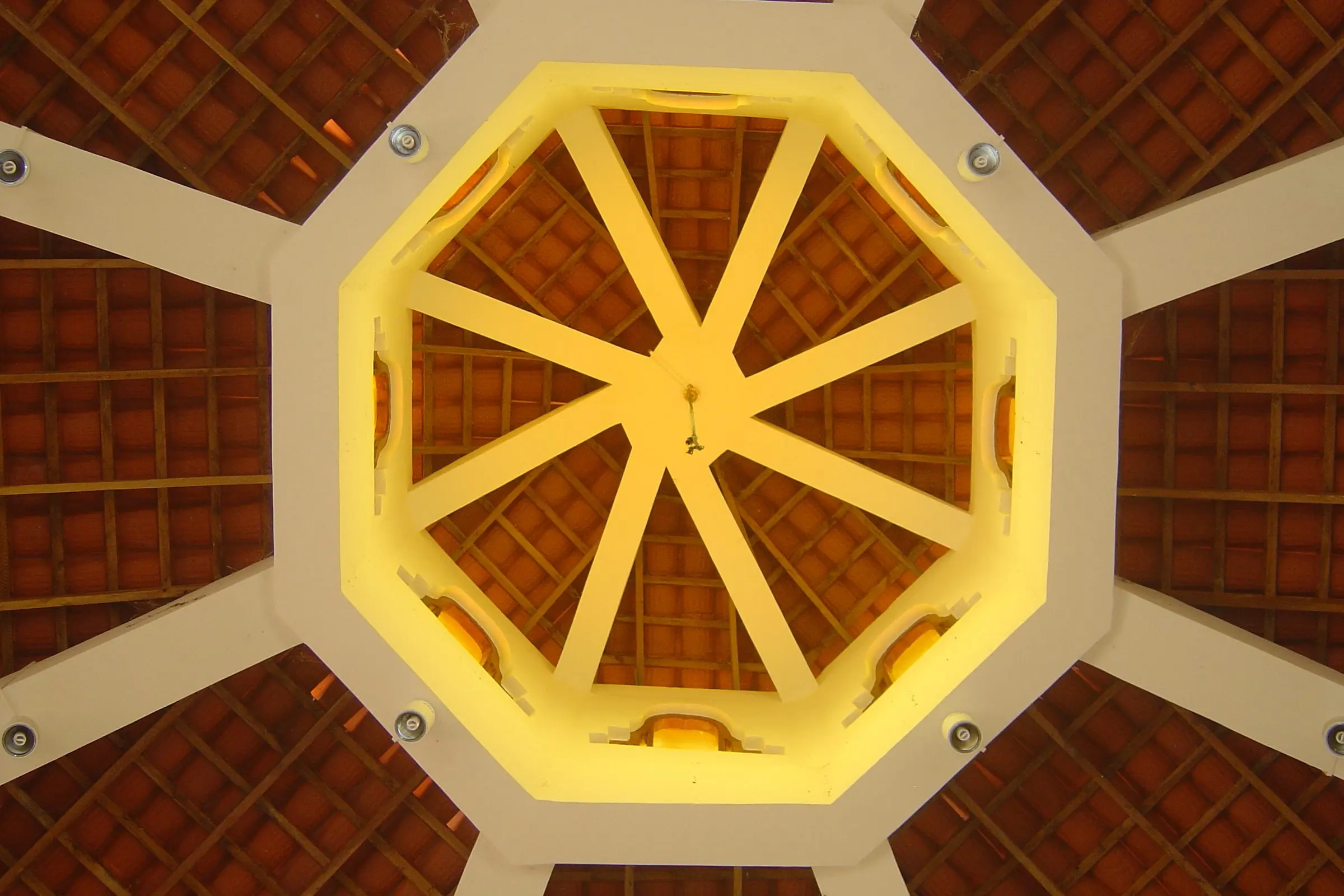 The roof from below: white ribs meeting at a lit octagonal lantern.